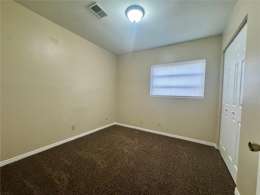 1516 Hawk Griffin Road Plant City, FL 33563 - Photo 12 of 17 an empty room with a empty space and a window