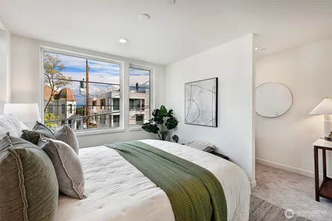 a bedroom with a large bed and a chandelier