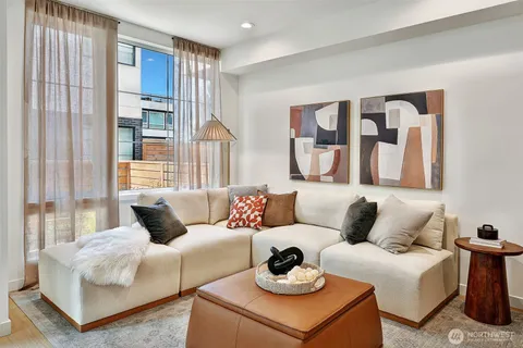 a living room with furniture and large windows
