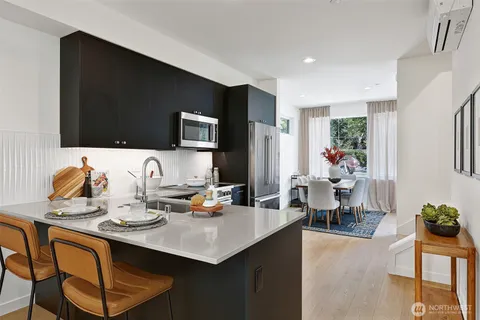 a kitchen with a sink cabinets and dining table