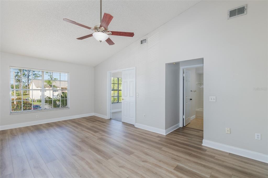 7900 Hardwick Drive, Unit 827 New Port Richey, FL 34653 - Photo 6 of 27 a view of an empty room with wooden floor and a window