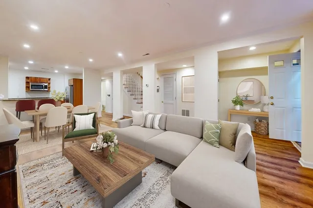 a living room with furniture and a wooden floor
