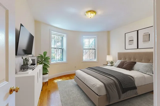 a bedroom with a bed and a flat screen tv