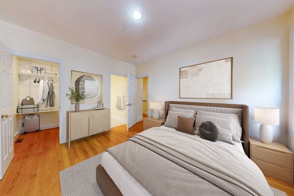 460 Massachusetts Avenue, Unit B Boston, MA 02118 - Photo 13 of 23 a bedroom with a bed and wooden floor