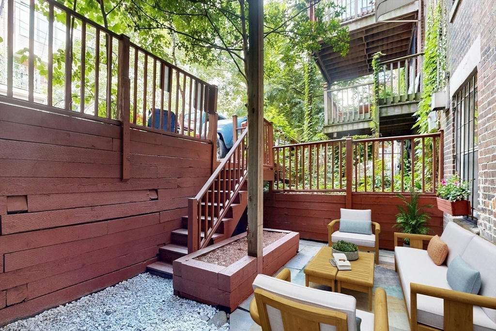 460 Massachusetts Avenue, Unit B Boston, MA 02118 - Photo 19 of 23 a view of a patio with couches chairs and wooden floor