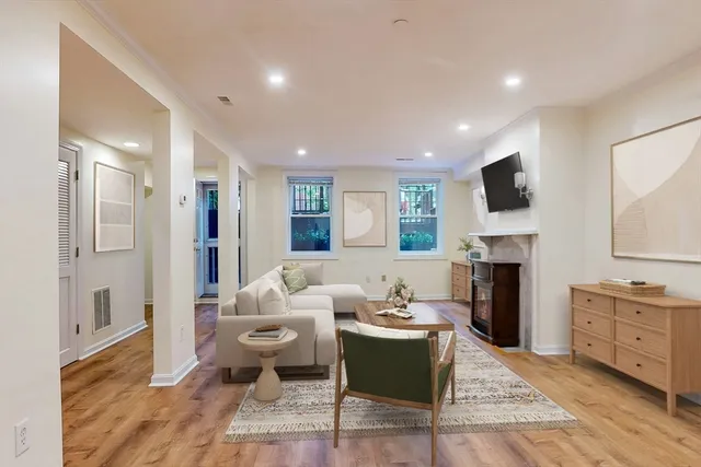 a living room with furniture a fireplace and a flat screen tv