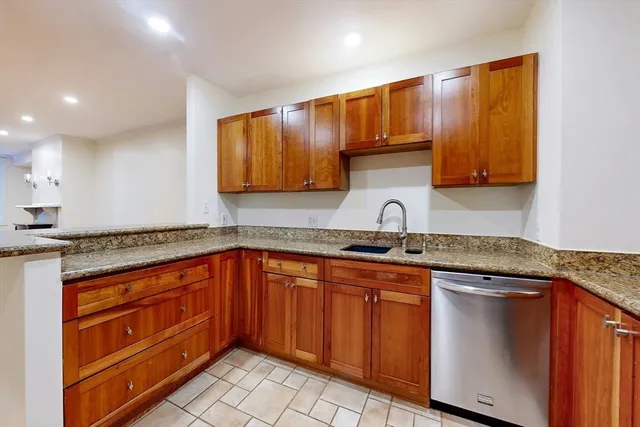 a kitchen with stainless steel appliances granite countertop a sink stove and cabinets
