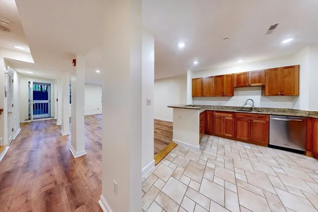 a kitchen with stainless steel appliances a refrigerator and a stove top oven