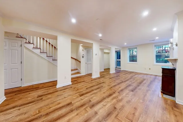 a view of empty room with wooden floor