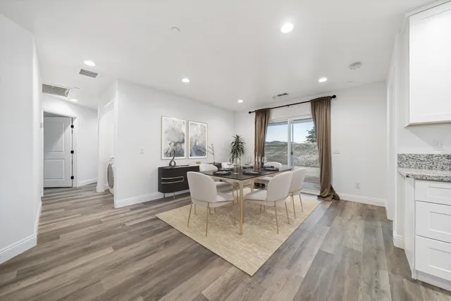 a view of a dining room with furniture window and wooden floor