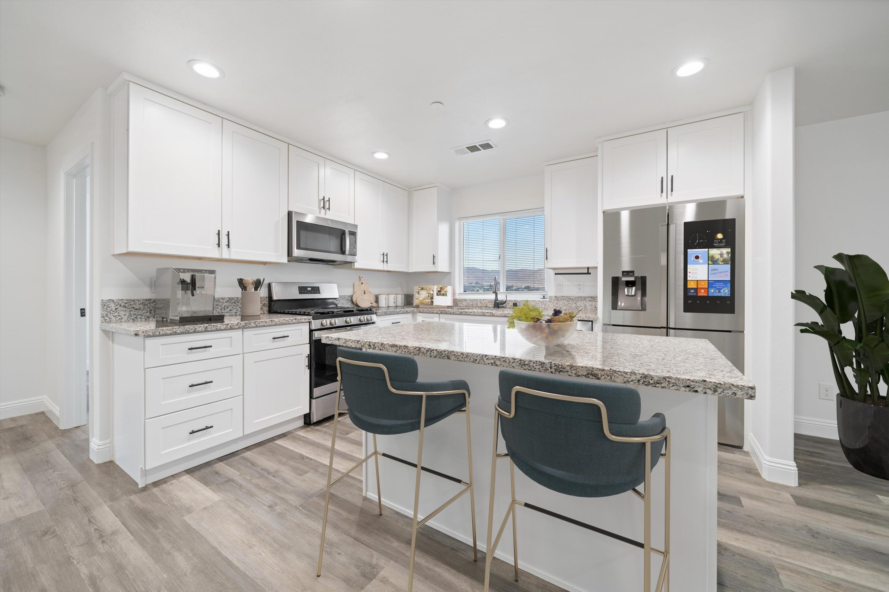 20601 Country Club Drive Tehachapi, CA 93561 - Photo 7 of 18 a kitchen with stainless steel appliances granite countertop a stove a sink a refrigerator and a microwave