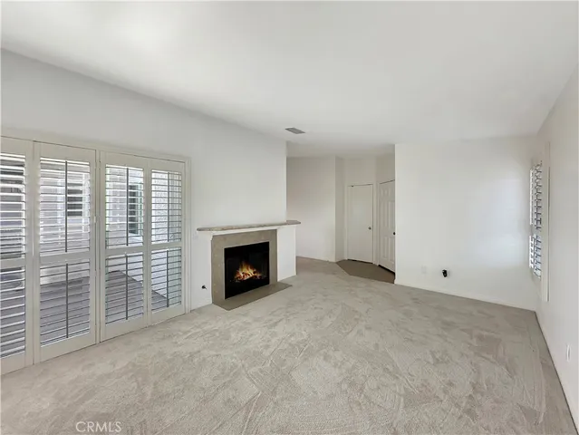 a view of an empty room with a fireplace