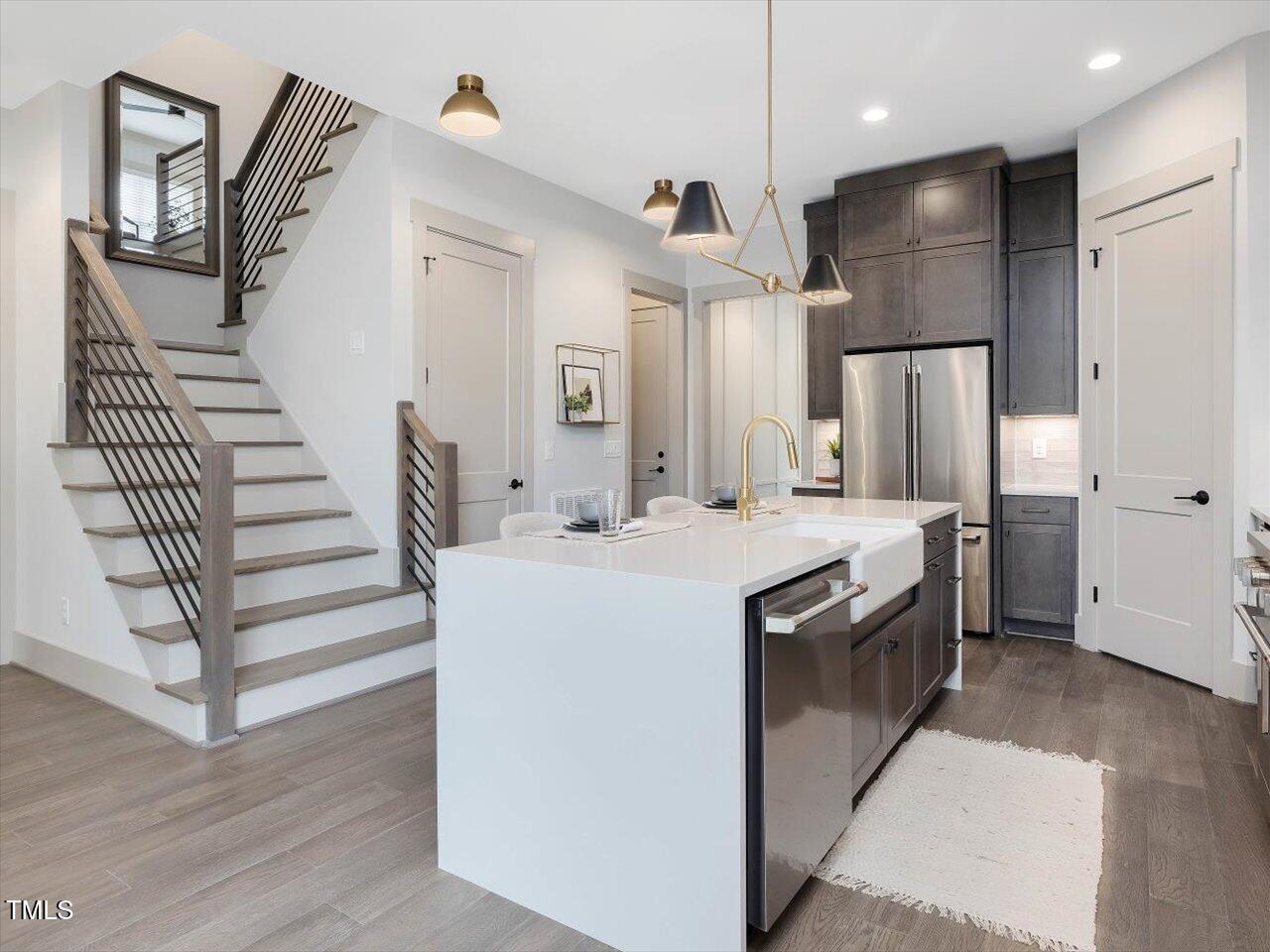 734 South State Street Raleigh, NC 27601 - Photo 29 of 95 a kitchen with kitchen island a sink stainless steel appliances and cabinets