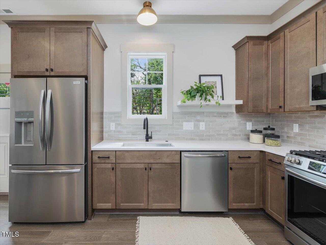 734 South State Street Raleigh, NC 27601 - Photo 74 of 95 a kitchen with appliances a sink and a window