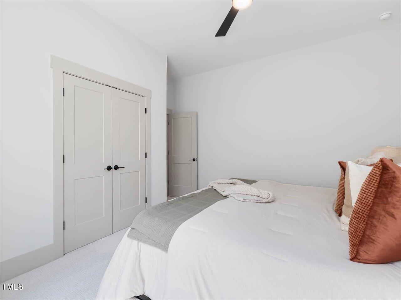 734 South State Street Raleigh, NC 27601 - Photo 84 of 95 a bedroom with a bed and a ceiling fan