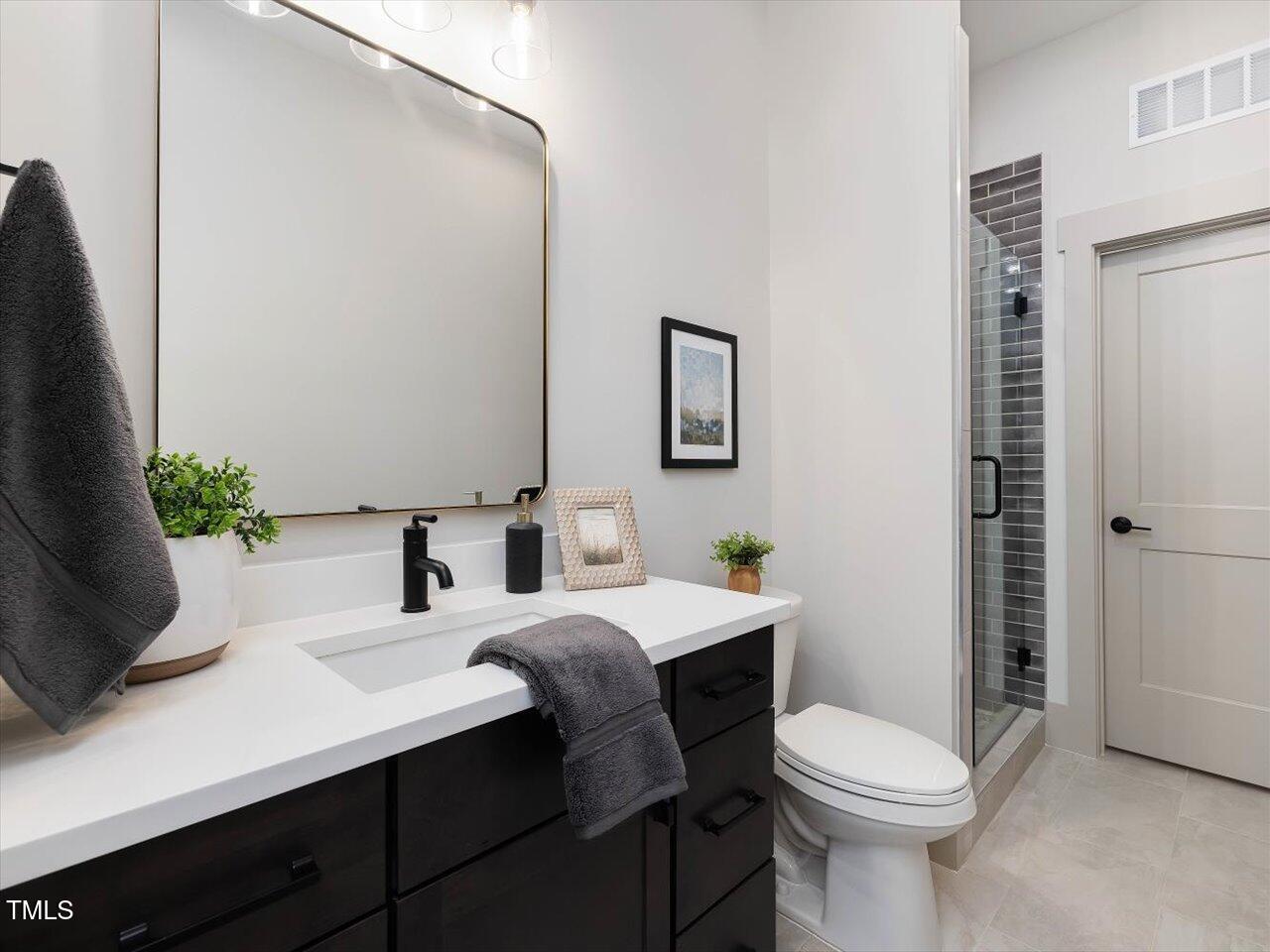734 South State Street Raleigh, NC 27601 - Photo 85 of 95 a bathroom with a sink a toilet and shower