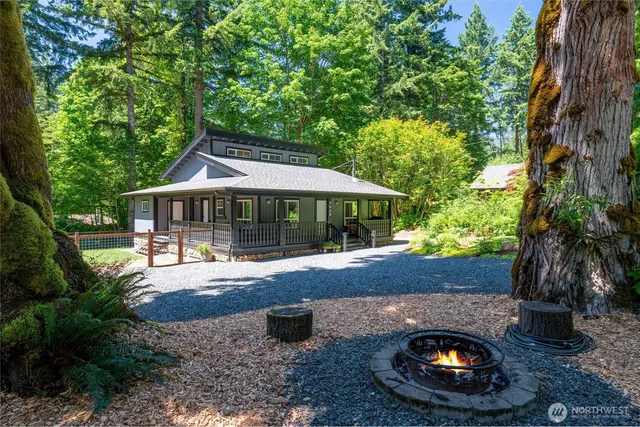 a view of a patio with table and chairs potted plants and large tree