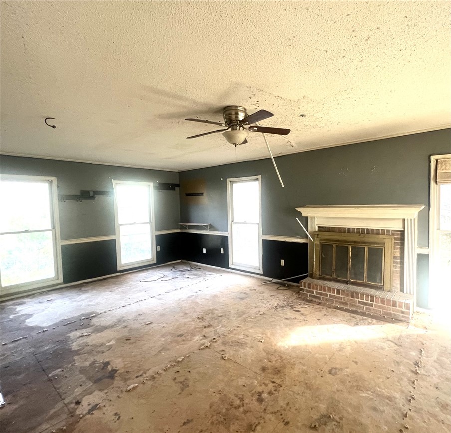 606 Timberlake Road Anderson, SC 29625 - Photo 3 of 12 This living room features a classic fireplace and ample natural light, awaiting your personal touch.
