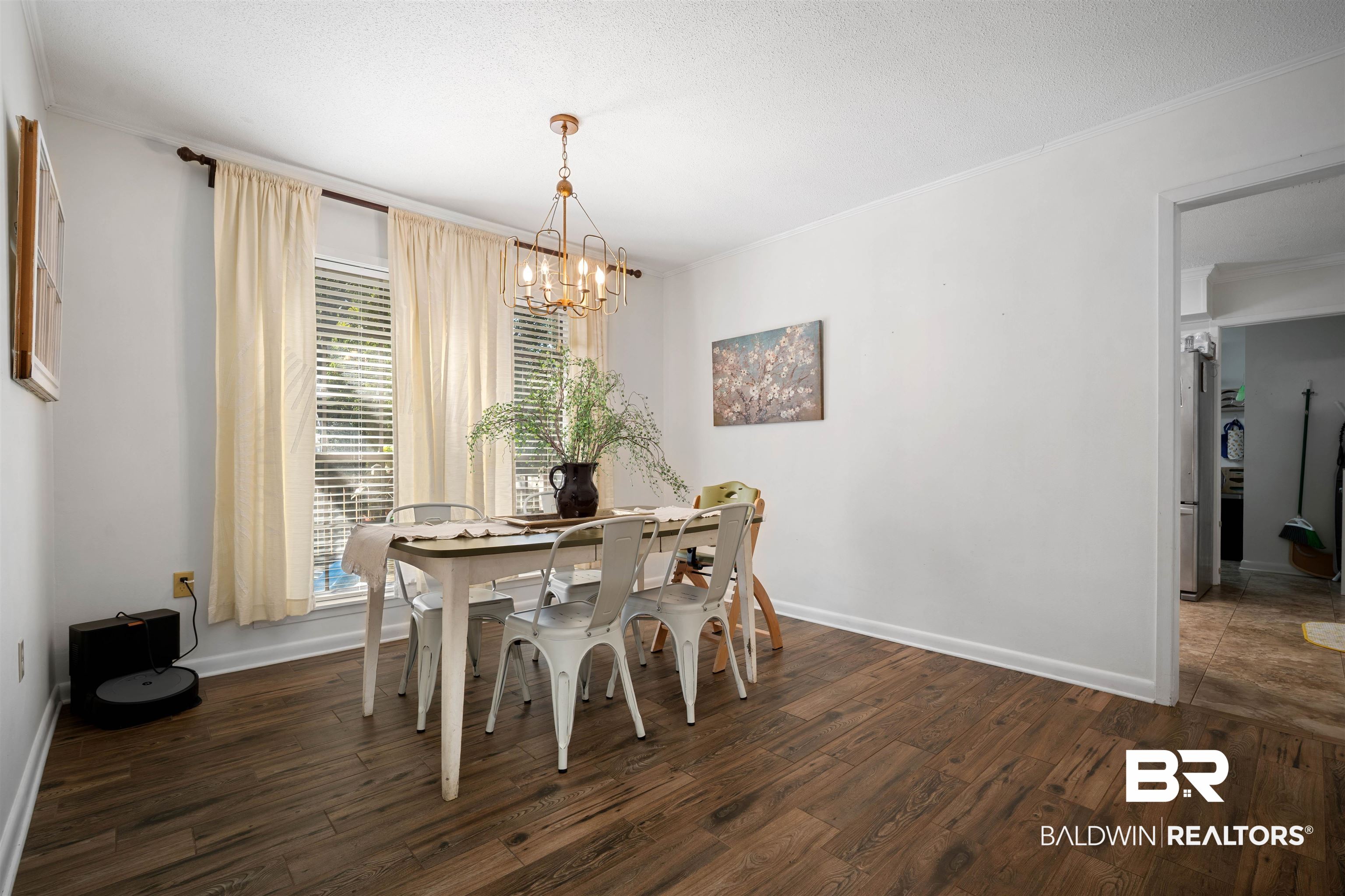 74 Caisson Trace Spanish Fort, AL 36527 - Photo 10 of 26 Dining space with dark wood-style floors, ornamental molding, a chandelier, and a textured ceiling