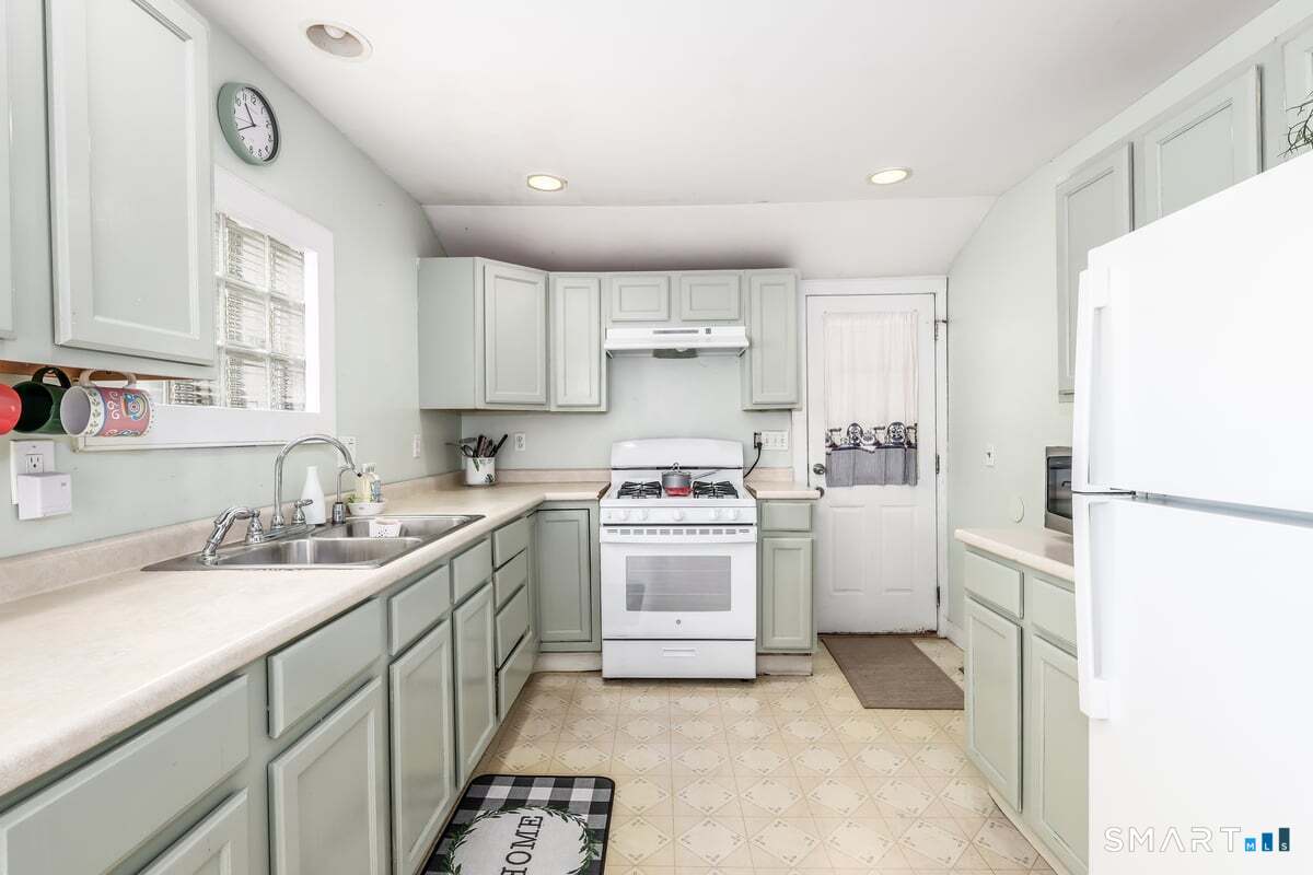70 Dodgingtown Road Bethel, CT 06801 - Photo 7 of 27 a kitchen with a sink cabinets and refrigerator