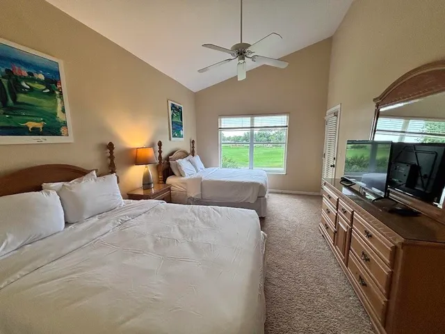 a bedroom with furniture and a flat screen tv