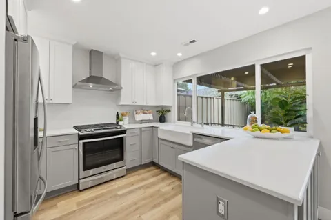 a kitchen that has a sink and a stove