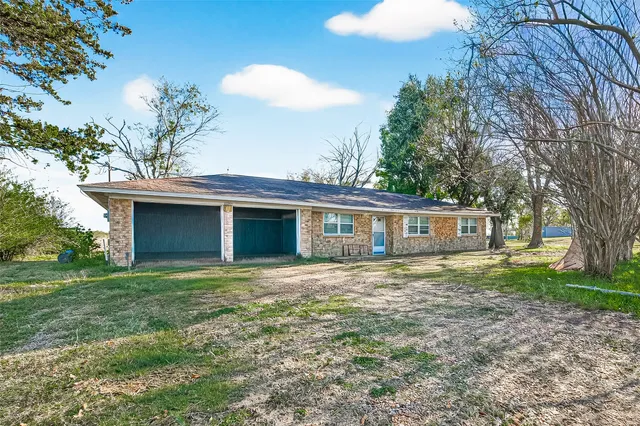 a house that has a tree in front of the house