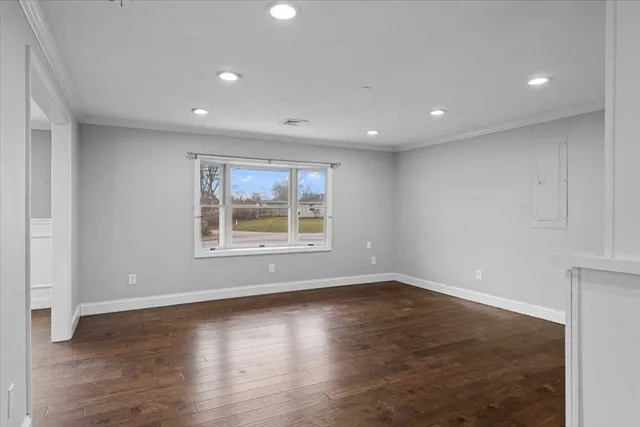 a bedroom with a bed and a television