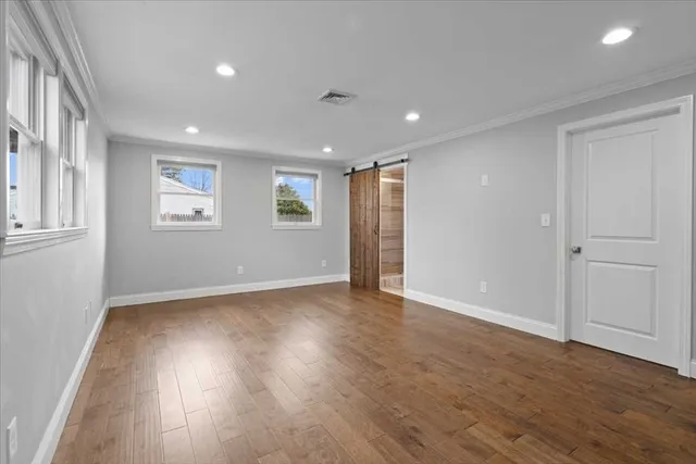 a view of walk in closet with empty racks