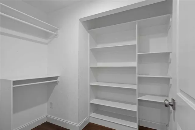 a bathroom with a granite countertop toilet a sink and shower