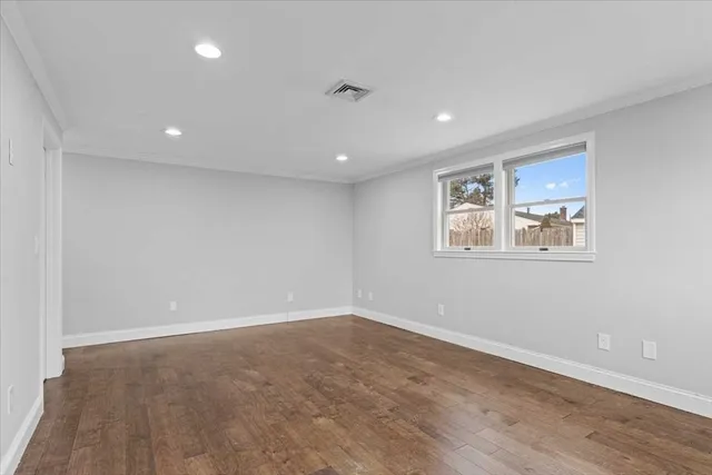 a bathroom with a granite countertop toilet sink and mirror