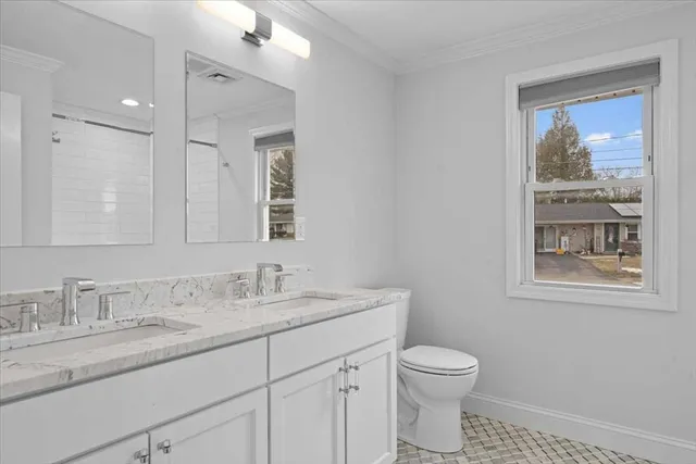 a bathroom with double sink and a mirror