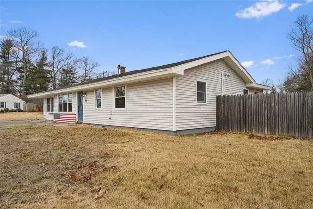 a view of a house with a backyard