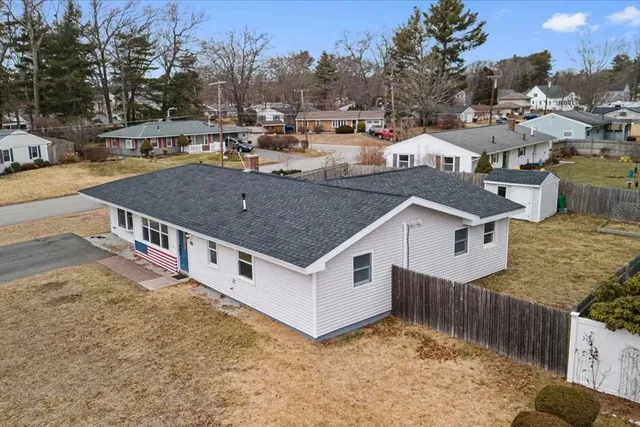 an aerial view of a house with a big yard