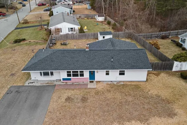 an aerial view of a house with large trees
