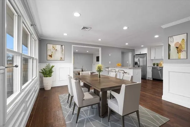 a view of a dining room with furniture window and wooden floor