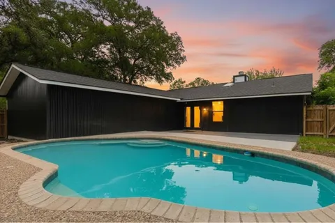 a view of swimming pool with a yard