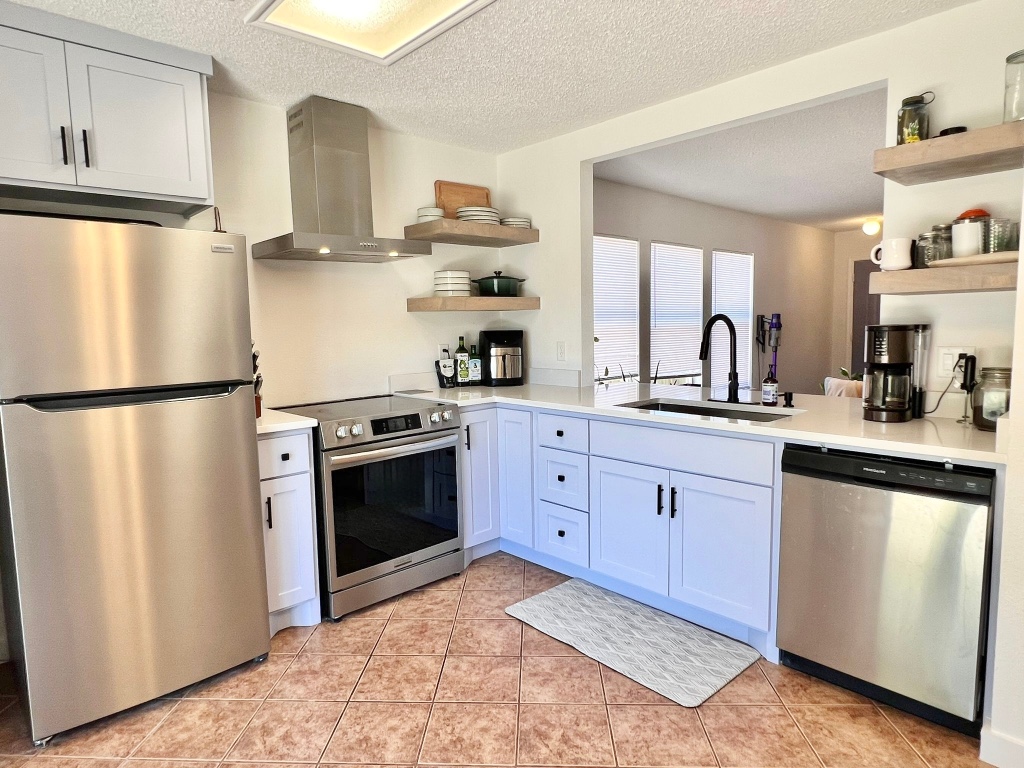 3204 Elizabeth Anne Lane Round Rock, TX 78664 - Photo 1 of 17 a kitchen with stainless steel appliances granite countertop a refrigerator a sink dishwasher a stove and white countertops with wooden floor