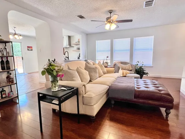a living room with furniture potted plant and a window