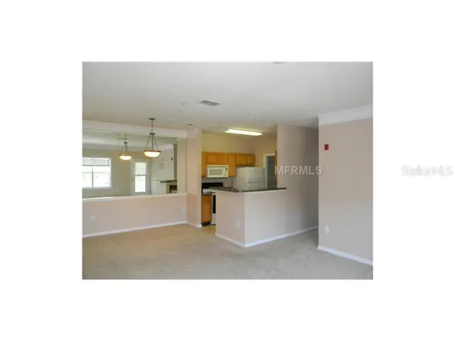 a view of a living room with kitchen island granite countertop couches and fireplace