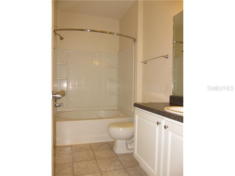 4802 51st Street West, Unit 1224 Bradenton, FL 34210 - Photo 10 of 10 a bathroom with a granite countertop sink toilet and shower