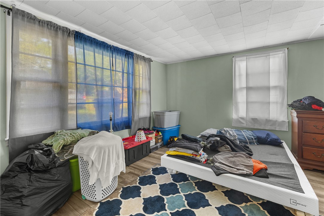 303 South Elm Street Pendleton, SC 29670 - Photo 14 of 16 This spacious bedroom offers abundant natural light, providing a comfortable and inviting atmosphere.