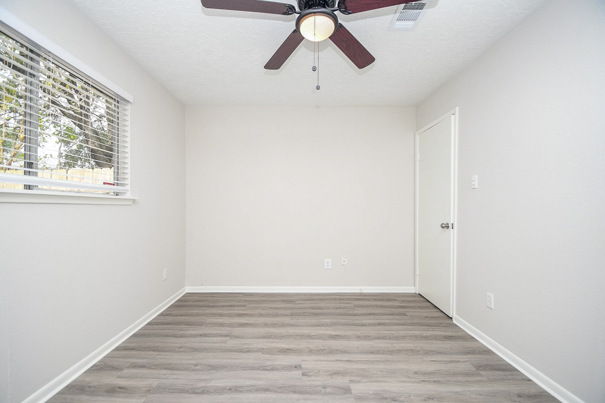 15315 Cedar Ridge Drive Houston, TX 77082 - Photo 14 of 20 a view of empty room with wooden floor and window