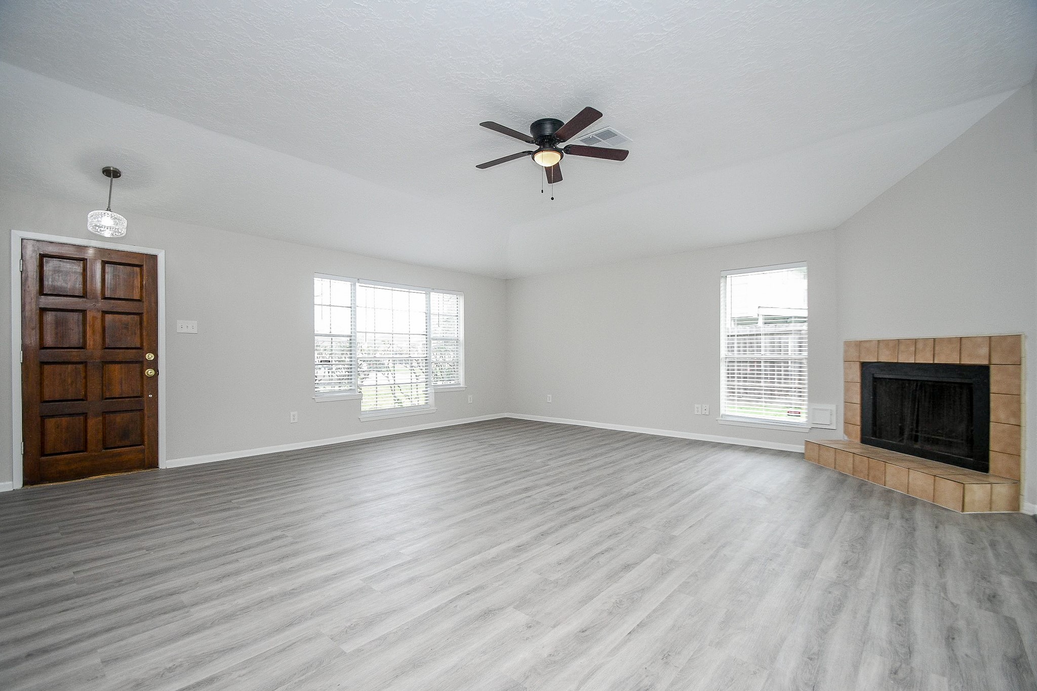 15315 Cedar Ridge Drive Houston, TX 77082 - Photo 3 of 20 a view of an empty room with a window and a fireplace