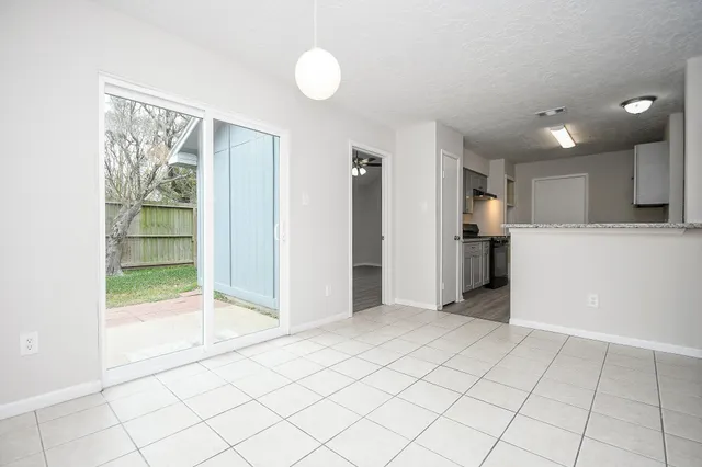 a view of a kitchen with an empty space and a window