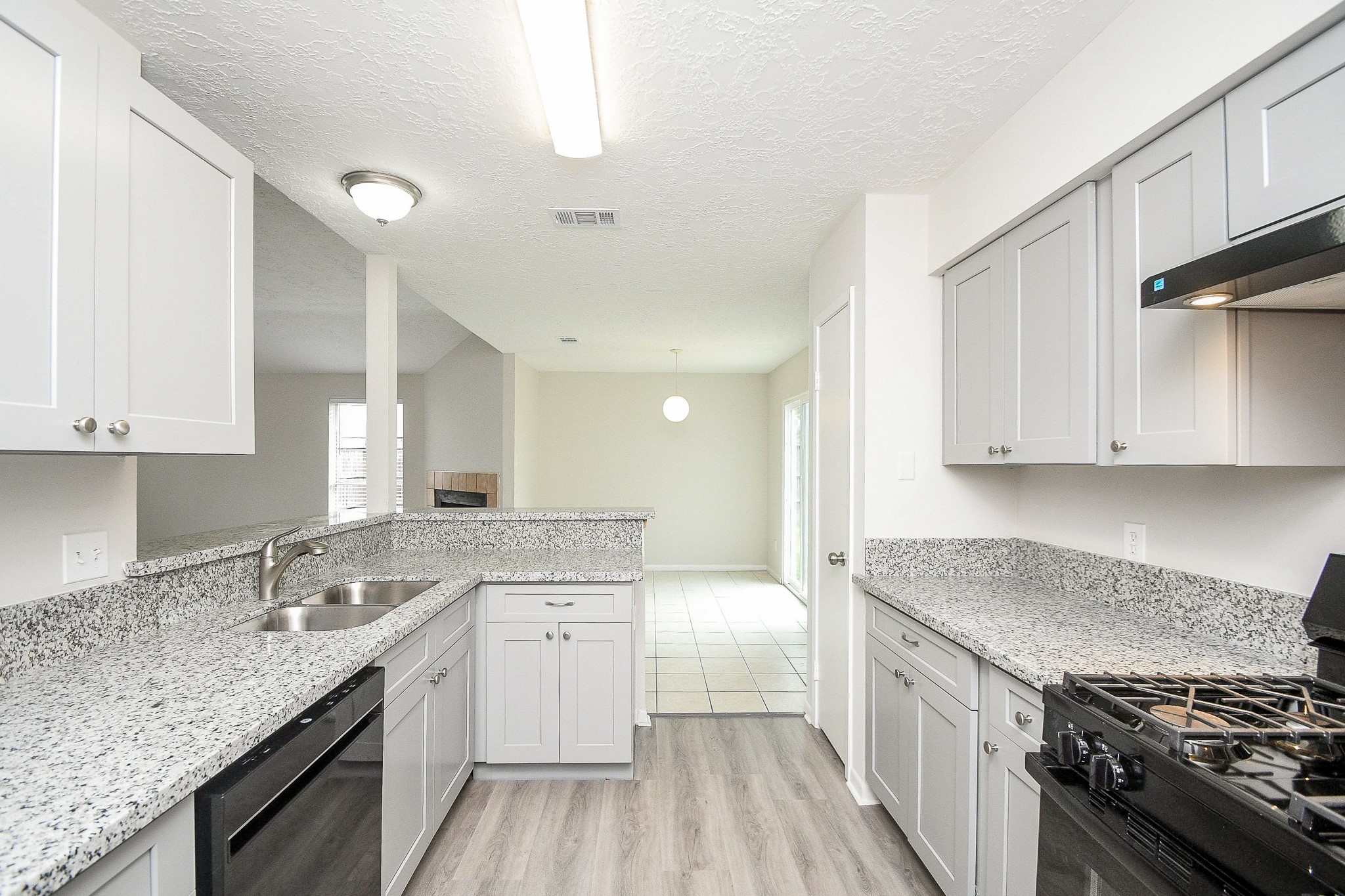 15315 Cedar Ridge Drive Houston, TX 77082 - Photo 9 of 20 a kitchen with granite countertop a sink stove and cabinets