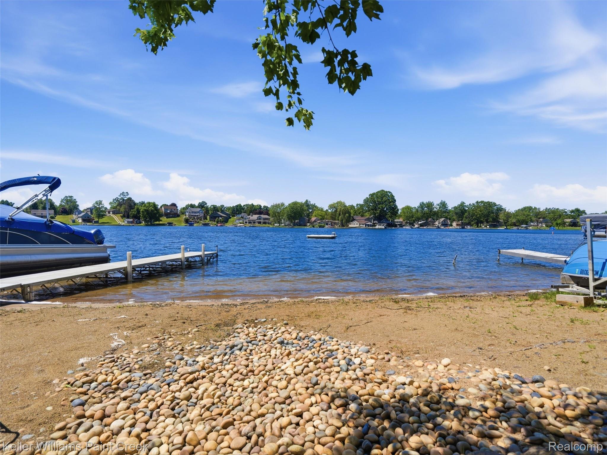 10435 Spring Street Fenton, MI 48430 - Photo 33 of 40 Waterfront property featuring a sandy beach, natural stone shore, and a private dock
