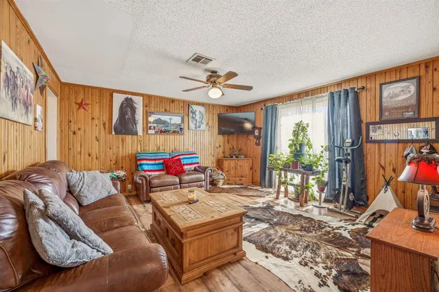 a kitchen with stainless steel appliances granite countertop a refrigerator a stove and a wooden floor