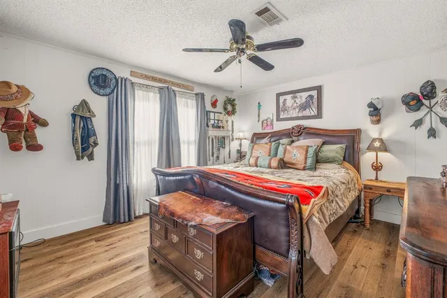 a bed sitting in a bedroom next to a window
