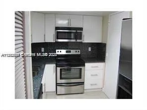 a kitchen with a stove and a microwave